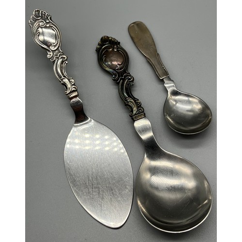 27 - A Lot of three Danish silver handle serving utensils. Two ornate handle utensils produced by Carl M ... 