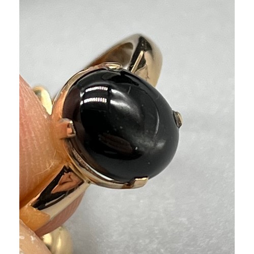 6 - A Yellow gold ring and matching earrings fitted with silver sheen black obsidian stones. Stamped 18.... 