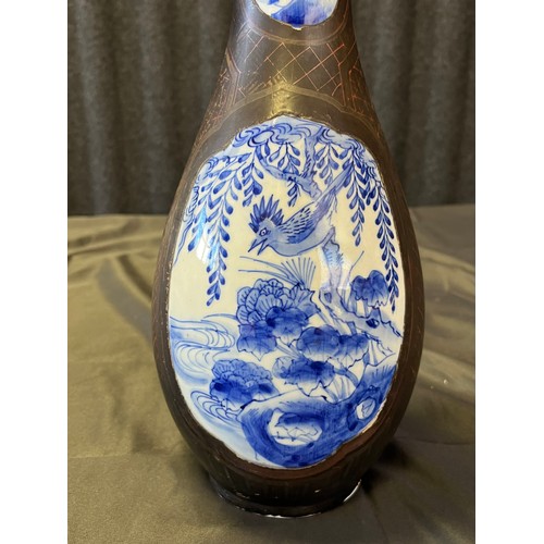 8 - A 19th century Chinese hand painted vase, detailed with blue and white panels, black and green groun... 