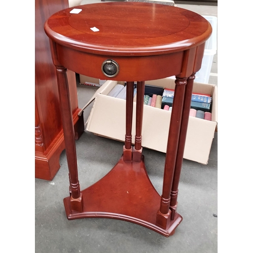 14 - A Contemporary mahogany drum top side table. [65cm high]