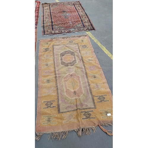 20 - Two small antique rugs. One in an Aztec style.