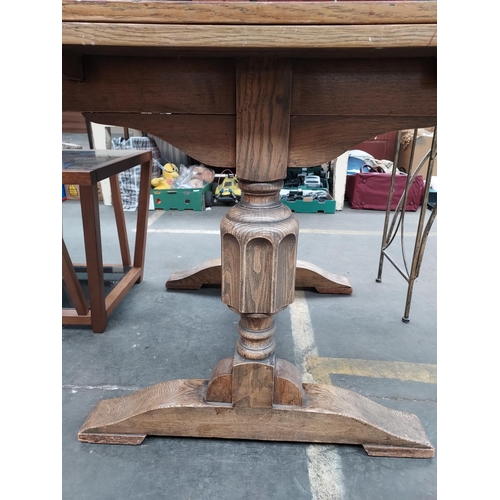 45 - An Art Deco light oak wood grain dining table. Comes with two leaves and heavy carved pedestal legs.... 