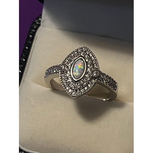 32j - A Silver and CZ Ring with central opal panel in a marquise shape.