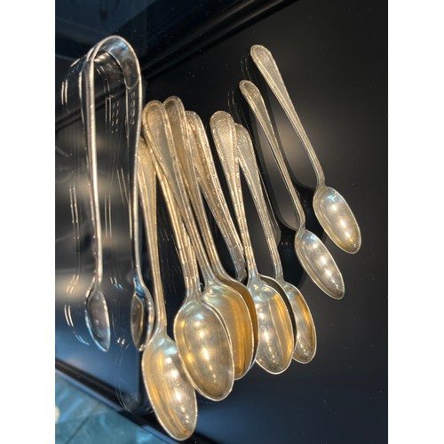 22 - A Set of 11 Victorian London silver tea spoons and a matching set of sugar tongs. [172.81Grams]