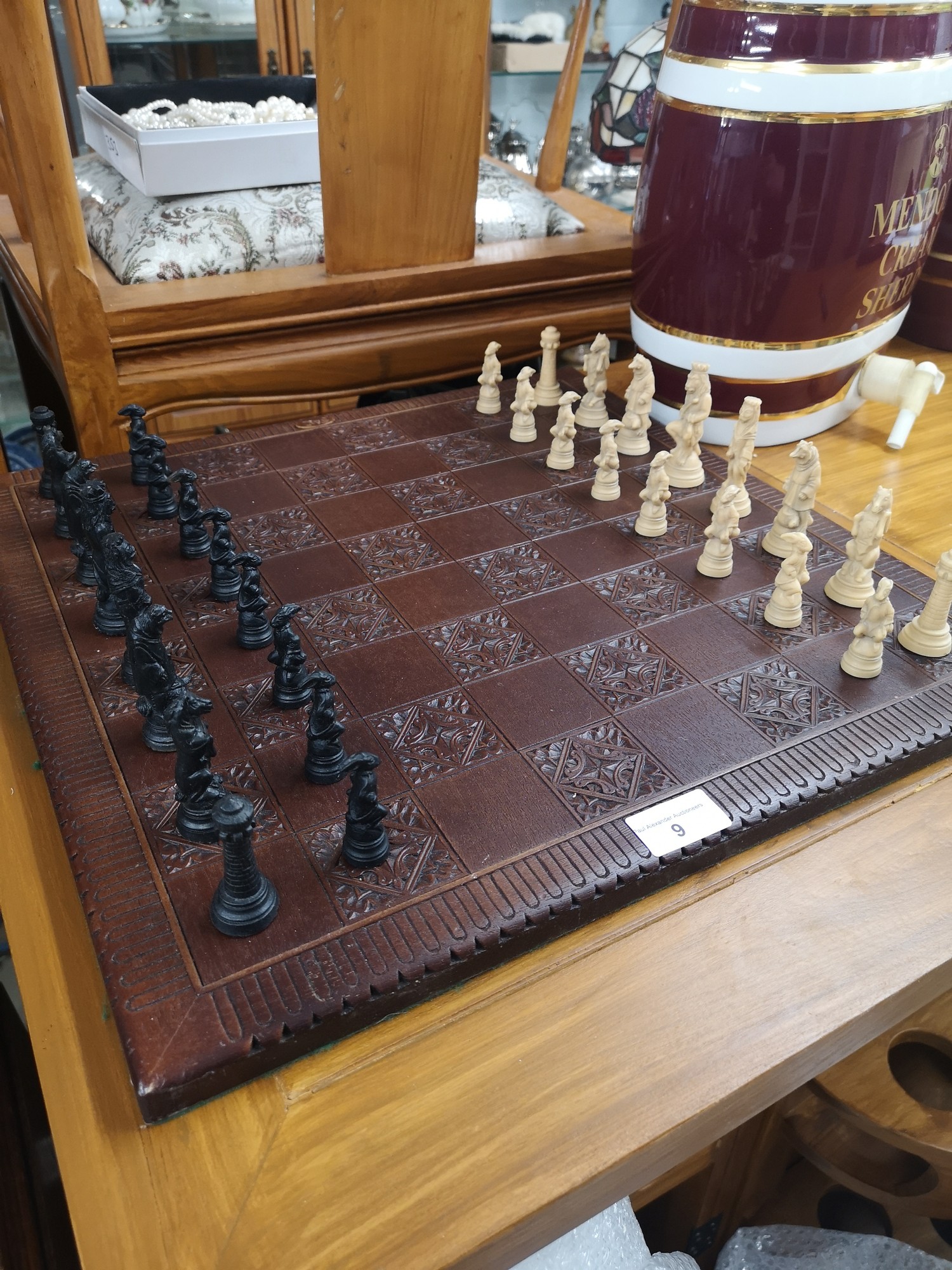 Large animal carved chess set with wooden board.