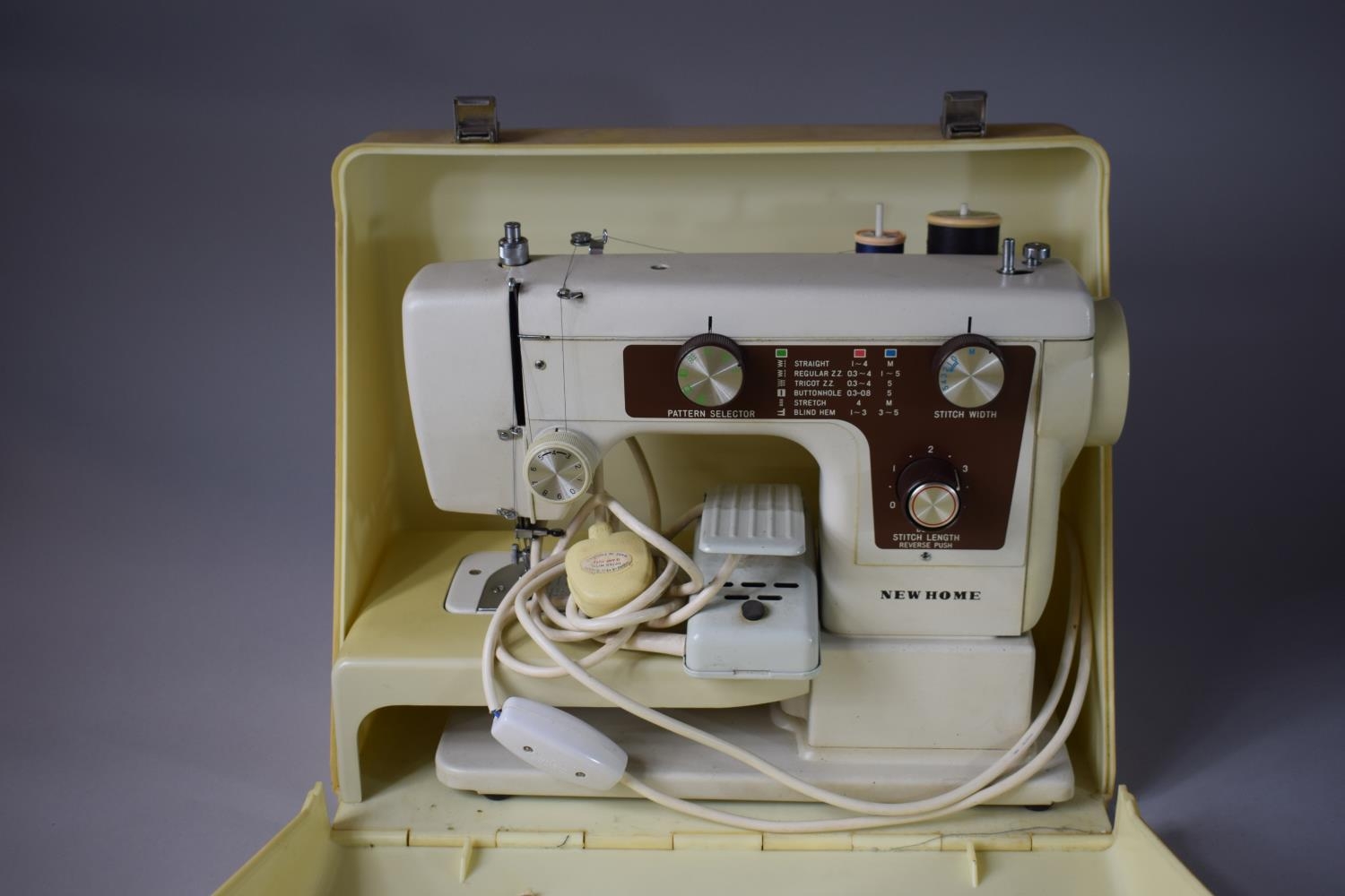 An Electric New Home Sewing Machine with Foot Pedal