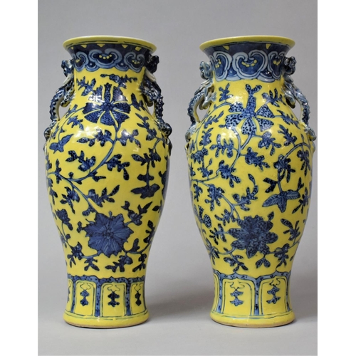 A Pair of 18th/19th Century Chinese Vases Painted in Under Glaze Blue with Floral Sprays with Over Glazed Painted Yellow Ground Having Stylised Twin Handles in the Form of Crawling Dragons, Tallest 29cm high, The One with Loss and Other Condition Issues etc