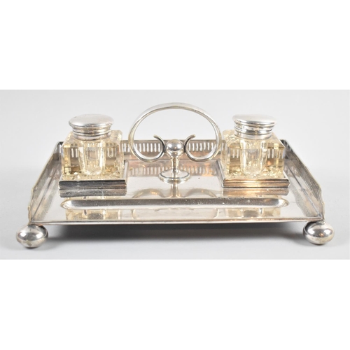 21 - A Late Victorian/Edwardian Silver Plated Desk Top Ink Stand with Two Glass Bottles, Pen well and Pie... 