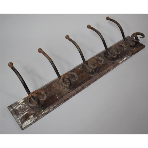 21 - A Vintage Wall Mounting Coat Rack with Five Cast Metal Hat and Coat Hooks, 60cm wide
