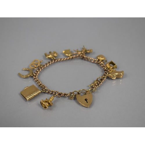 51 - A 9ct Gold Charm Bracelet with Various 9ct Gold Charms and One 18ct Gold Example, 9ct Gold Charms to... 