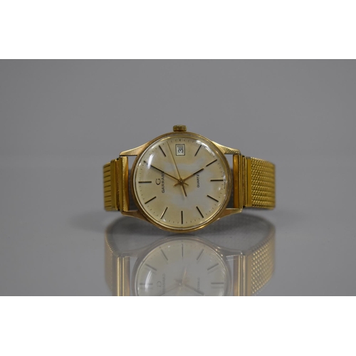 17 - A 9ct Gold Cased Garrard Wrist Watch, Champagne Dial having Baton Indicators and with Additional Dat... 