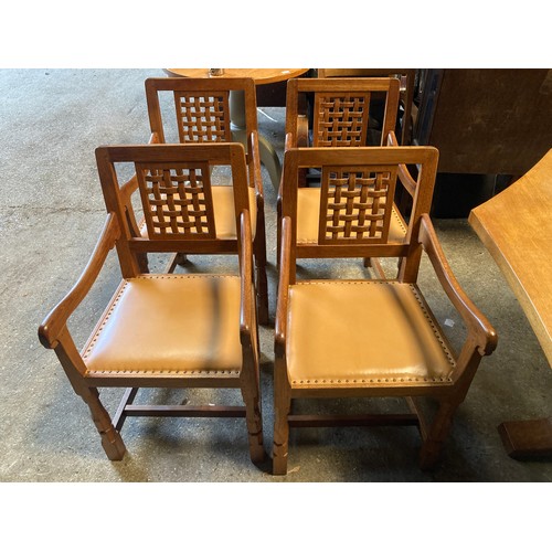 1262 - Four Robert ''Mouseman'' Thompson oak carver dining chairs each with lattice carved back and close s... 