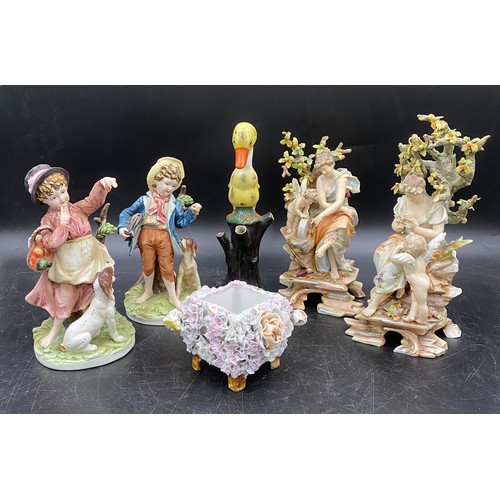 60 - A selection of Continental ceramics to include two pairs of figurines one of ladies with cherubs 22c... 