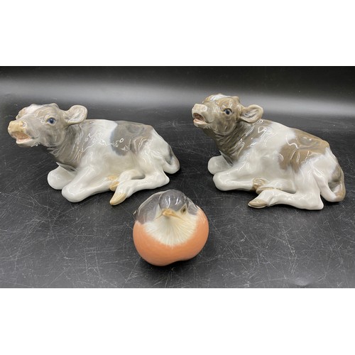 64 - Two Royal Copenhagen calf figurines 1072, one marked IL the other SF together with a Royal Copenhage... 
