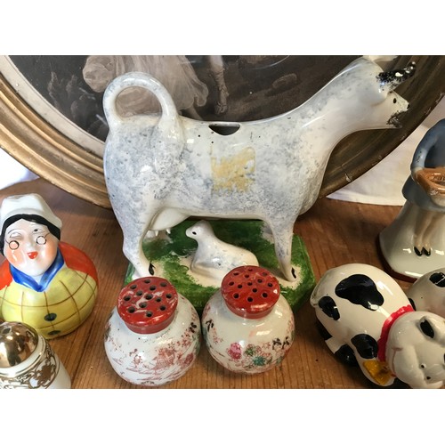 42 - A collection of ceramic salt and pepper pots together with a Leeds classical creamware cow creamer t... 