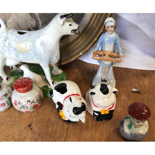 42 - A collection of ceramic salt and pepper pots together with a Leeds classical creamware cow creamer t... 