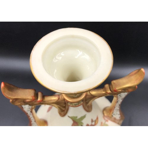 10 - A Royal Worcester lidded vase with floral decoration and pierced dragon headed handles. 41cms.