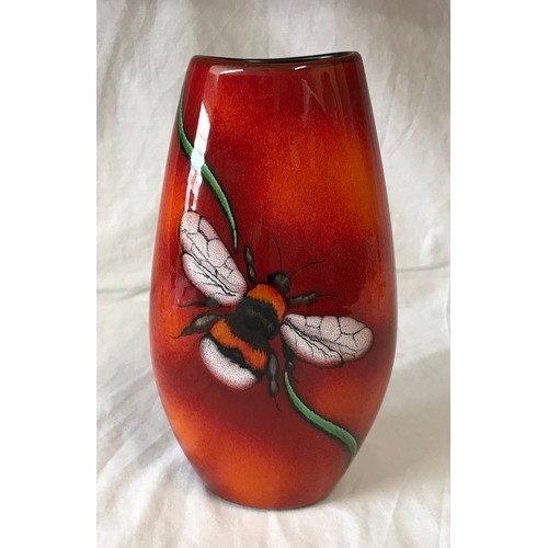 30 - A Poole Pottery vase with Bee decoration to front on a red and orange glazed background. 25cms h.