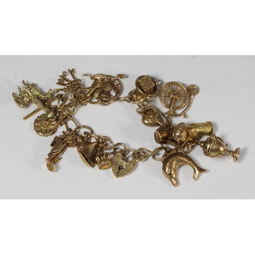 A 9ct gold charm bracelet with a collection of assorted 9ct ...