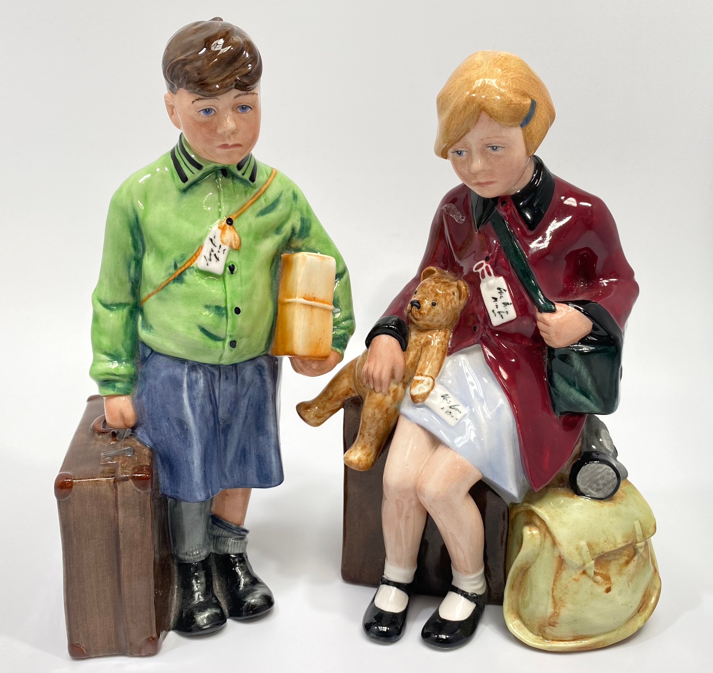 A pair of Royal Doulton figures of child evacuees, ‘The Boy Evacuee