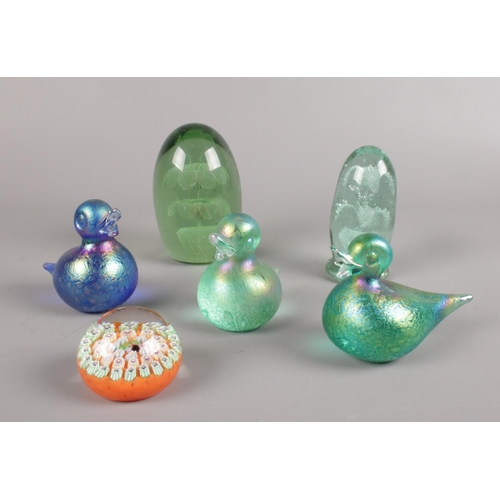 28 - A group of glass paperweights. Victorian glass dumps, iridescent ducks and a John Deacons millefiori... 