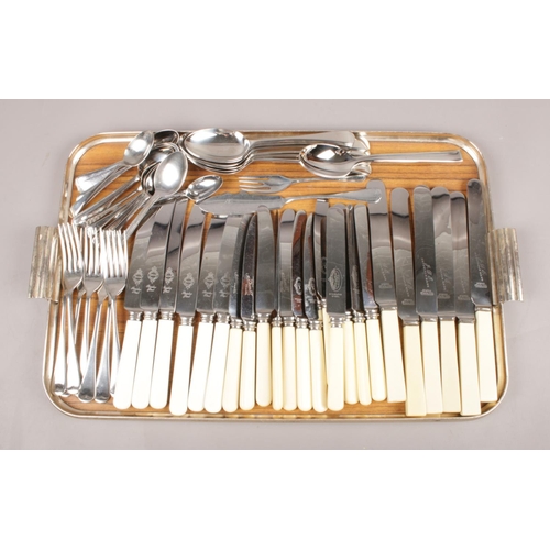 54 - A tray of mostly Sheffield made cutlery. Comprising of knives with composite handles, & spoons etc.