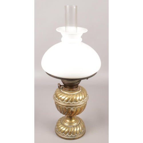 24 - A brass oil lamp with milk glass shade.