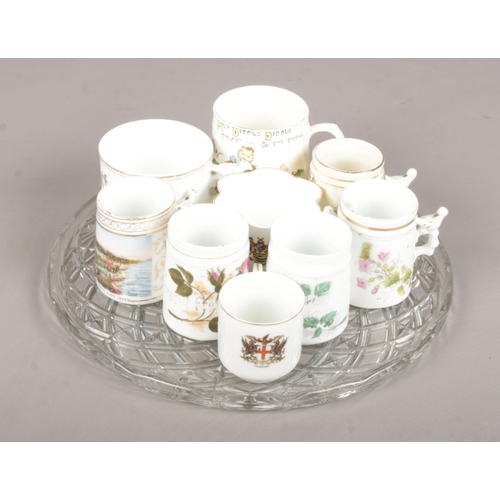 24 - An Assortment of Mainly Whistle Mugs together with Glass Serving Tray.