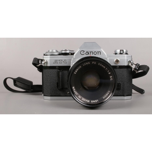 4 - A Canon AT-1 Camera with Canon 50mm FD Lens, along with a cased Ozeck II 28mm Lens and Hanimex TZ/1 ... 