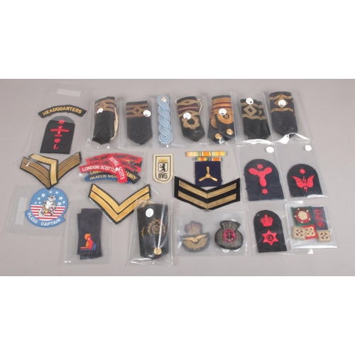 40 - A Large Assembly of Military Lapels and Badges.