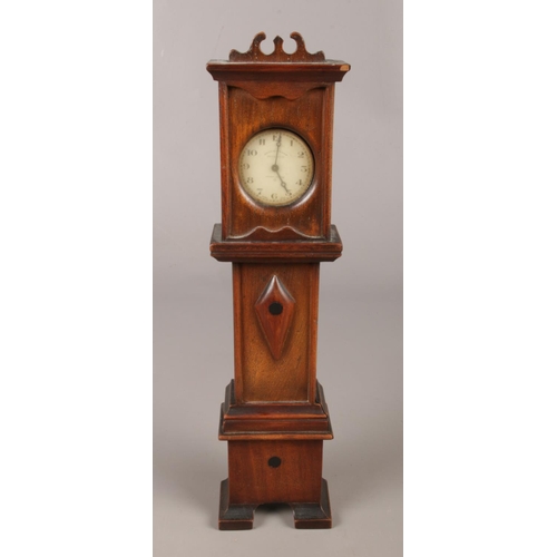 30 - An Inventic white metal pocket watch, housed in a miniature mahogany longcase clock stand.