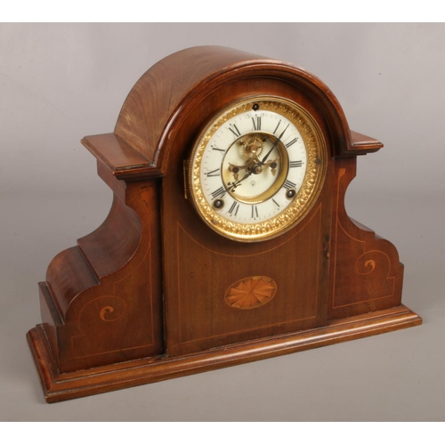39 - A mahogany cased Ansonia mantel clock. With fan patera inlay, chiming on a coiled gong.