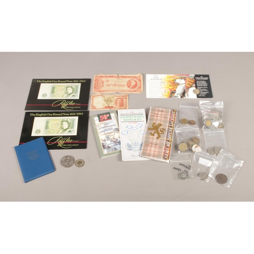 14 - A selection of bank notes and coins from around the world. To include two one pound notes , The Lion... 