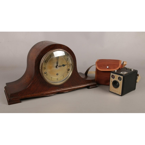 29 - A vintage oak cased Napoleon hat mantle clock, along with a cased Kodak six-20 Brownie D camera.