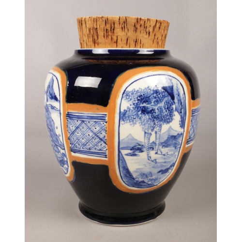 60 - A large Japanese ginger jar with cork stopper. Stamped Japan on the base along with symbol. Jar depi... 