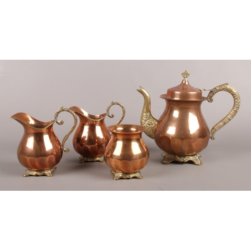10 - A four piece copper and brass coffee set, with floral decoration to feet and handles. To include cof... 