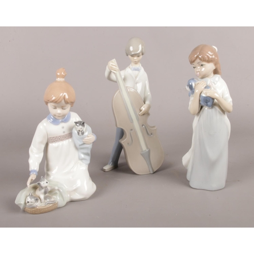 44 - Three Lladro/Nao figurines. girl with kittens, boy with cello etc