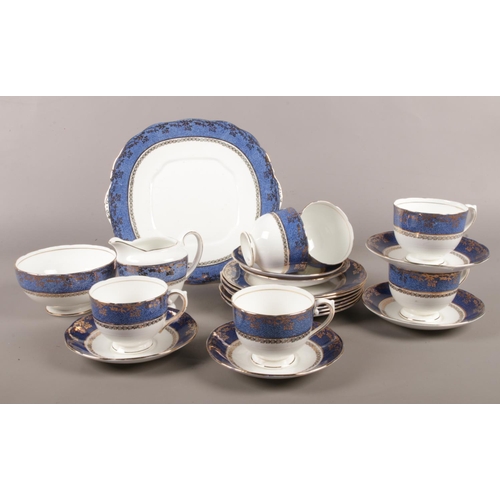 55 - A Salisbury blue/gold part tea set. cups/saucers, milk jug, sugar bowl etc.