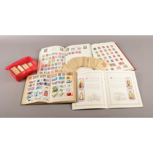 57 - A collection of world stamps, albums and Player's Cigarette cards.