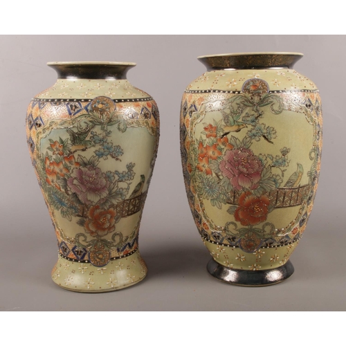 59 - Two Chinese made vases. Comprising of raised floral and bird decoration. Largest: H:31cm