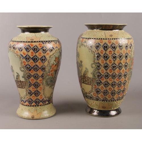 59 - Two Chinese made vases. Comprising of raised floral and bird decoration. Largest: H:31cm