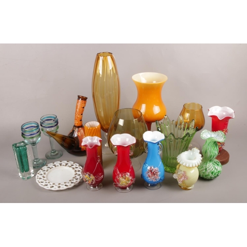 18 - A large quantity of coloured art glass. Including vases, pedestal bowl, drinking glasses, etc.