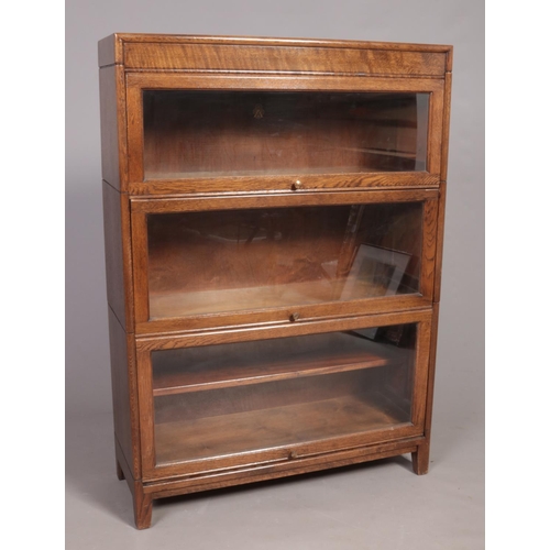 A three-section oak modular bookcase. mid-20th century, by Gunn, the top section stamped 'Angus'.