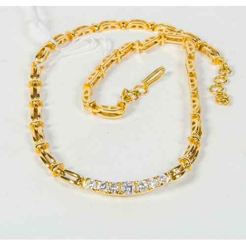 97 - A Gold and Diamond line necklace, mounted with 7 graduated diamonds.
32 grams.