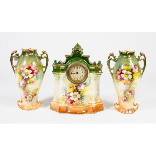 134 - A Late 19th Century, floral green glazed pottery garniture, consisting of a clock and 2 side vases. ... 