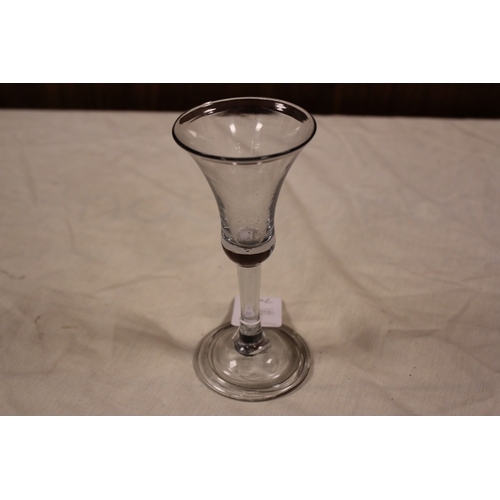 297 - A Georgian tear drop shaped wine glass, resting on a plain stem, with a fold over foot.