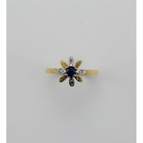 132 - An 18 carat gold diamond and sapphire ring, flower head shaped.
