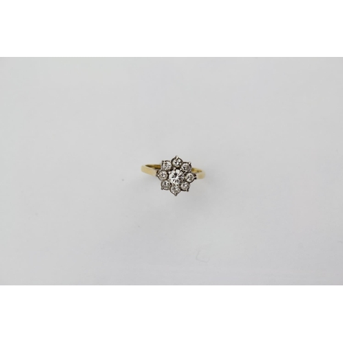 114 - A Ladies Diamond Ring set with 8 small Diamonds & one larger Diamond mounted in an 18ct Gold Frame. ... 