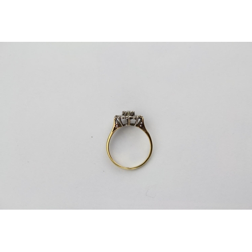114 - A Ladies Diamond Ring set with 8 small Diamonds & one larger Diamond mounted in an 18ct Gold Frame. ... 