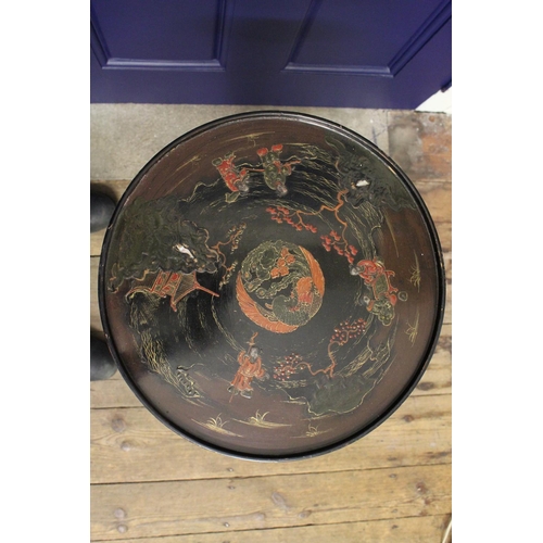 255 - A 1920's lacquered and decorated wine table decorated in the Chinoiserie style resting on a shaped b... 